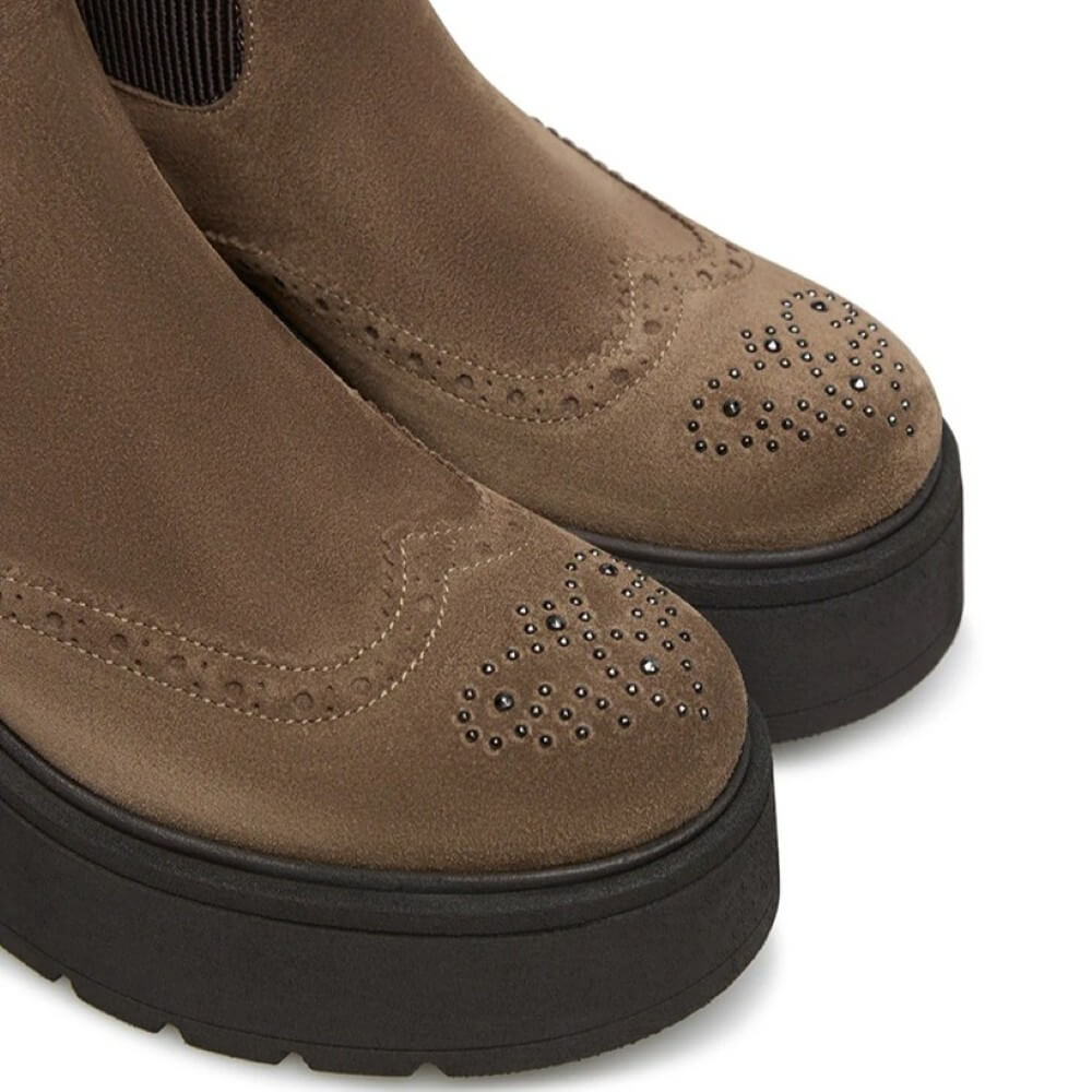 Brown suede platform boots with decorative studs on a white background