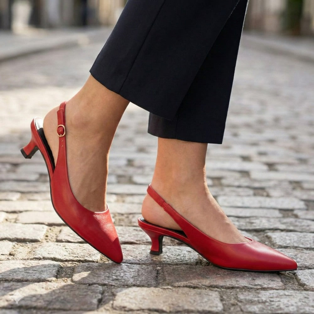 Red slingback heels worn on a cobblestone street