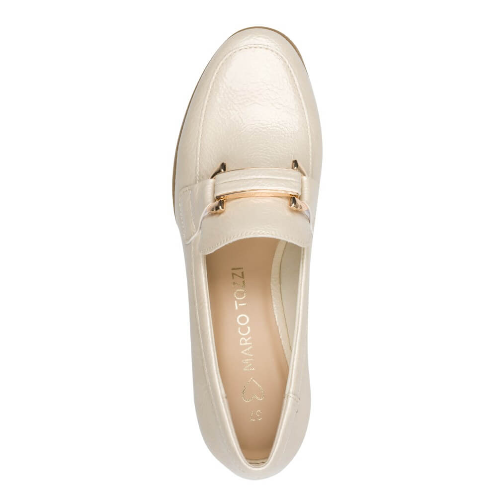 Beige slip-on shoe with a gold buckle on a white background