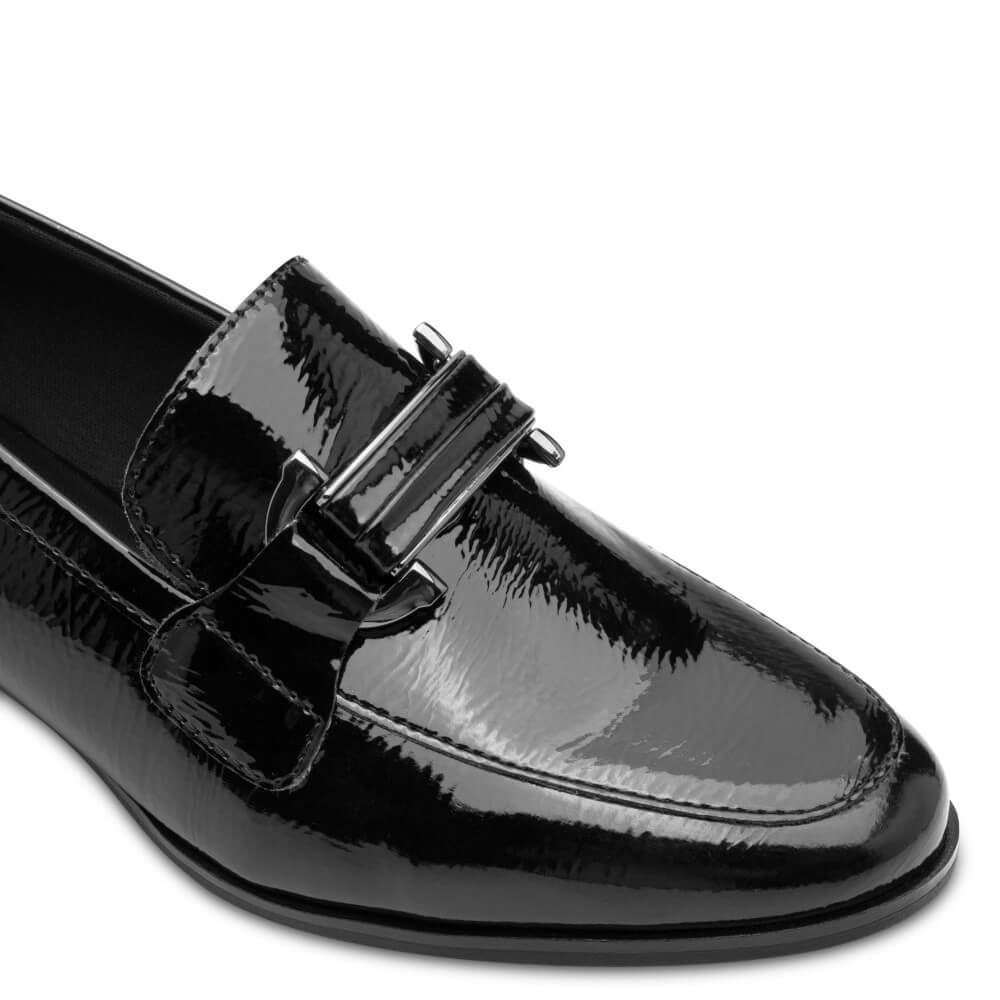 Black patent leather loafer shoe on a white background