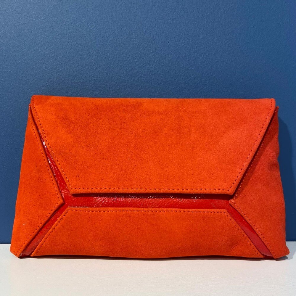 Orange clutch bag on a blue and white background
