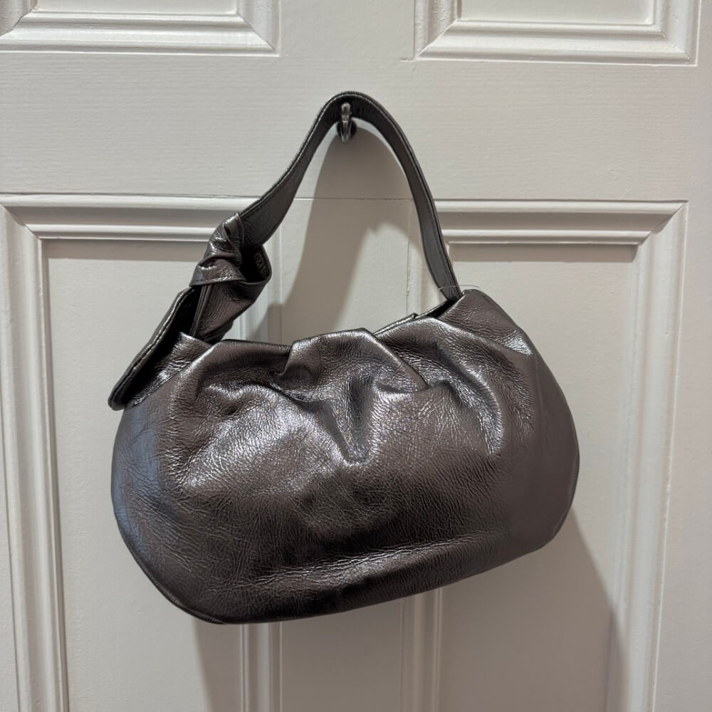 Grey handbag on a white door