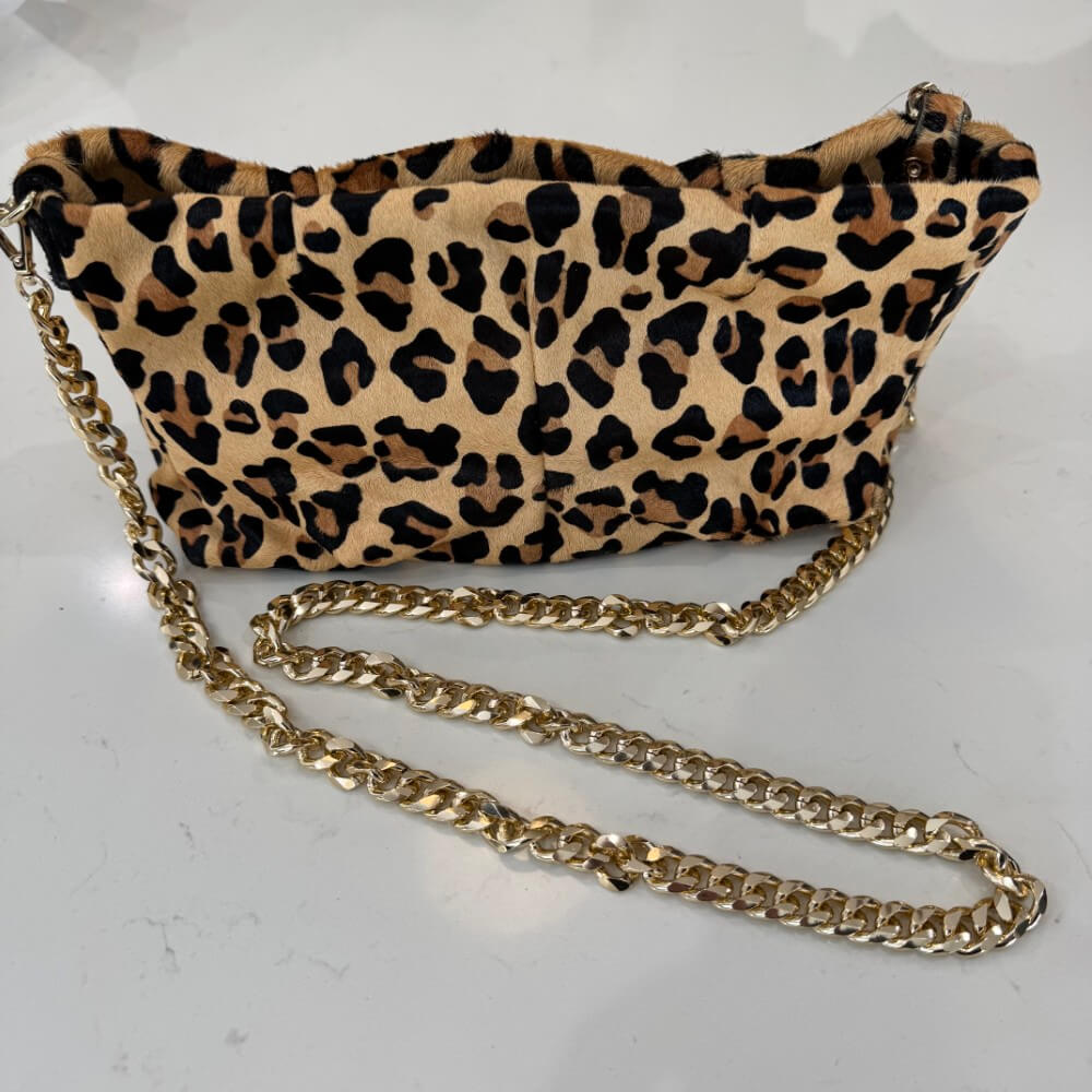Leopard print handbag with a gold chain on a white background