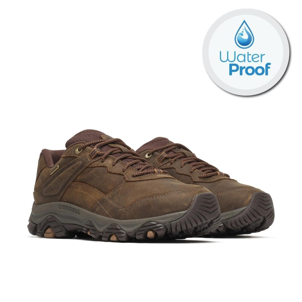 A pair of Merrell brown waterproof hiking shoes shown from a three-quarters angle on a white background, with a circular 'Water Proof' badge in the top right corner.
