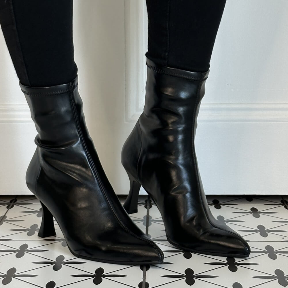 Miss Elastic Black Stretch ankle boots with kitten heels, worn with black leggings on a patterned black and white tile floor.