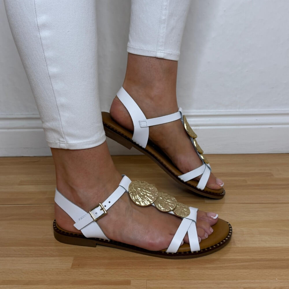 Oh My Sandals 5849 White sandals with gold embellishments worn on a wooden floor.