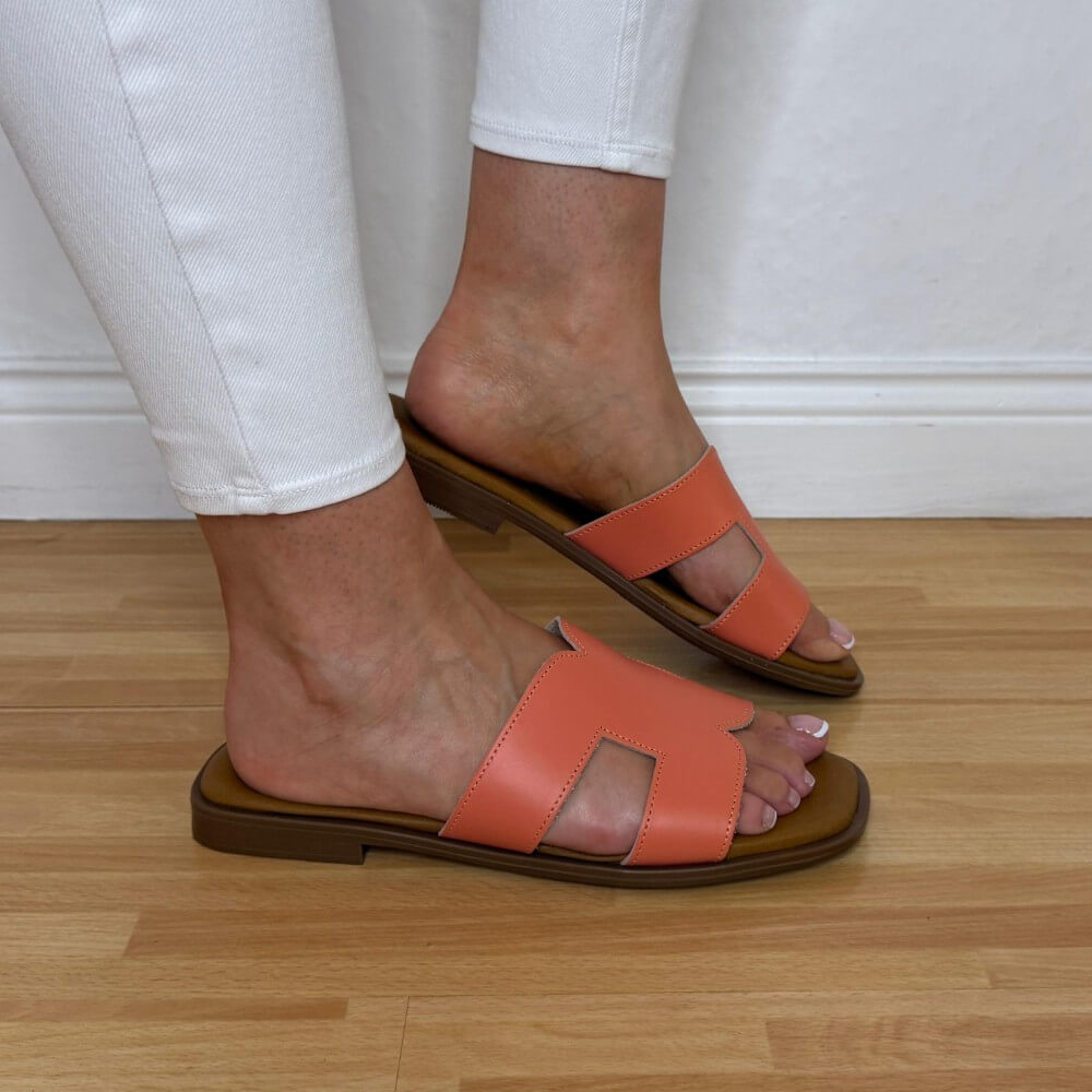 Person wearing Oh MY sandals 5580 orange sandals on a wooden floor