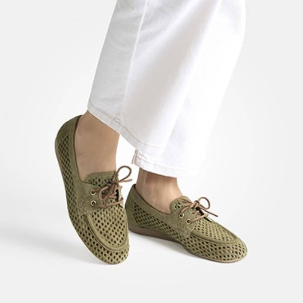 Person wearing Paul Green 1218 Green Suede Moccasins on a white background