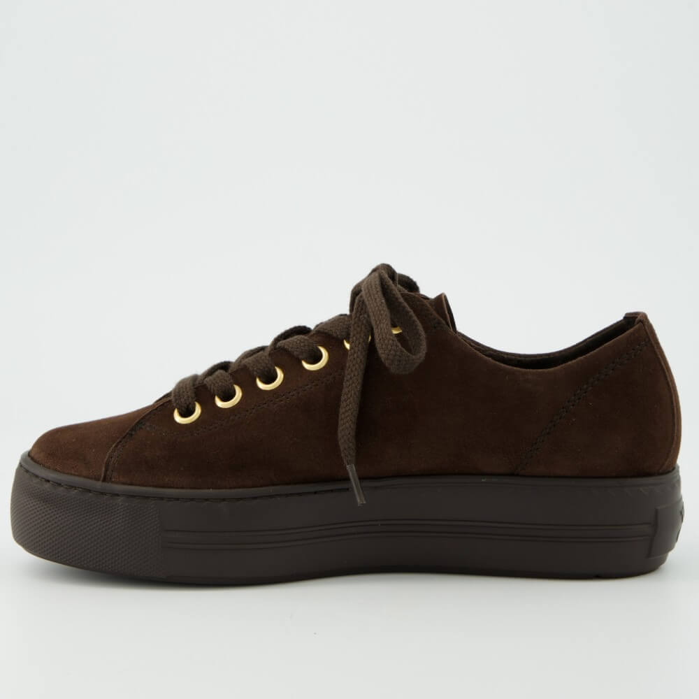 A Paul Green dark brown suede low-top sneaker with a matching dark brown platform sole, brown laces, and gold-tone metal eyelets and zipper accents, shown on a light grey background.