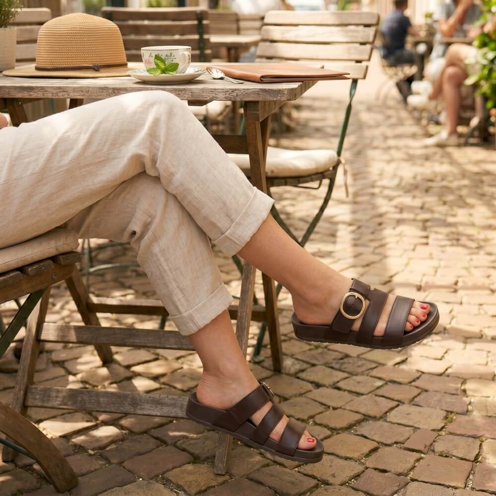 Paul Green 6171 Brown sandals worn on a cobblestone surface