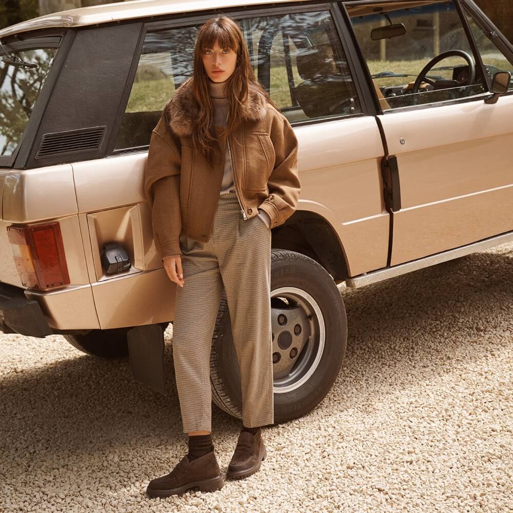 Person Standing Infront of a Range rover wearing Paul Green Boots