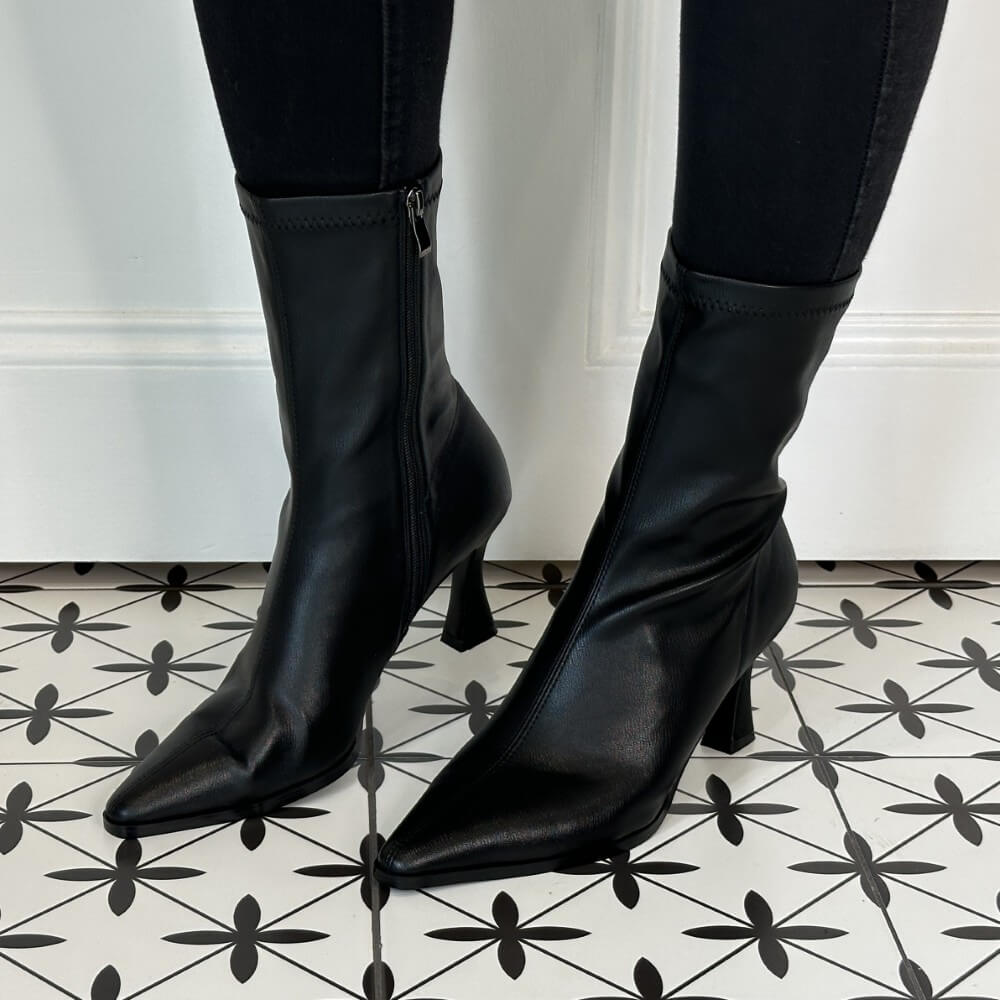Black high-heeled boots on a patterned floor Pedro Anton Cork Heel Sock Boot Black