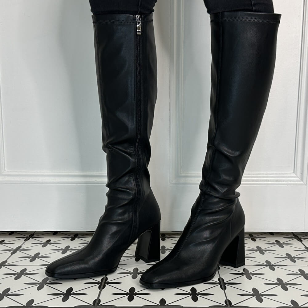 Person Wearing Knee high black boots