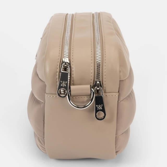 Beige backpack with silver zippers and hardware on a white background