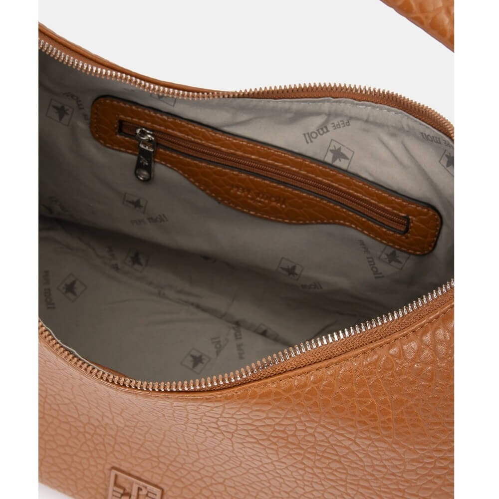 Close-up of a brown leather bag with visible stitching and brand logo.