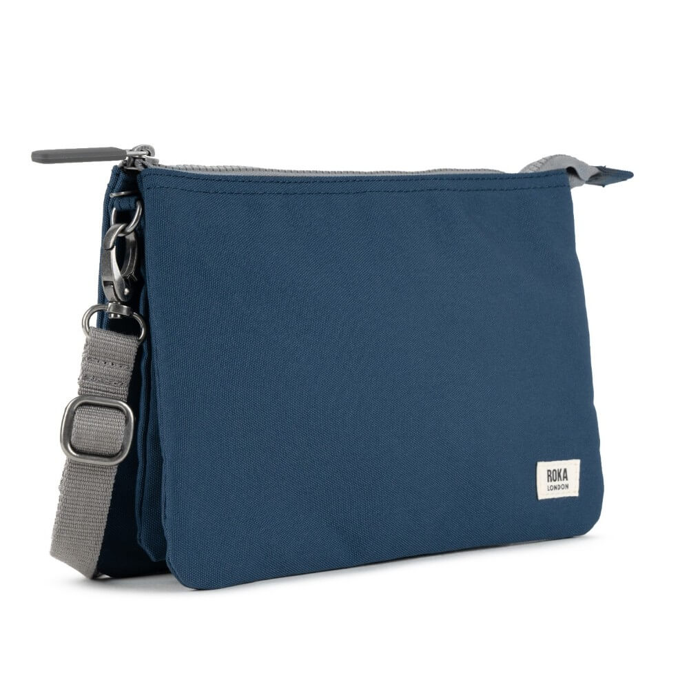 Roka Blue crossbody bag with a visible brand label on a white background
