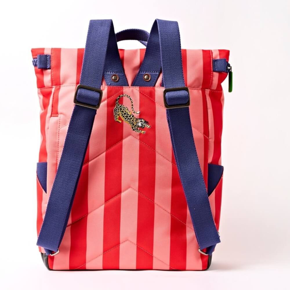 Red and pink striped backpack with blue straps on a white background