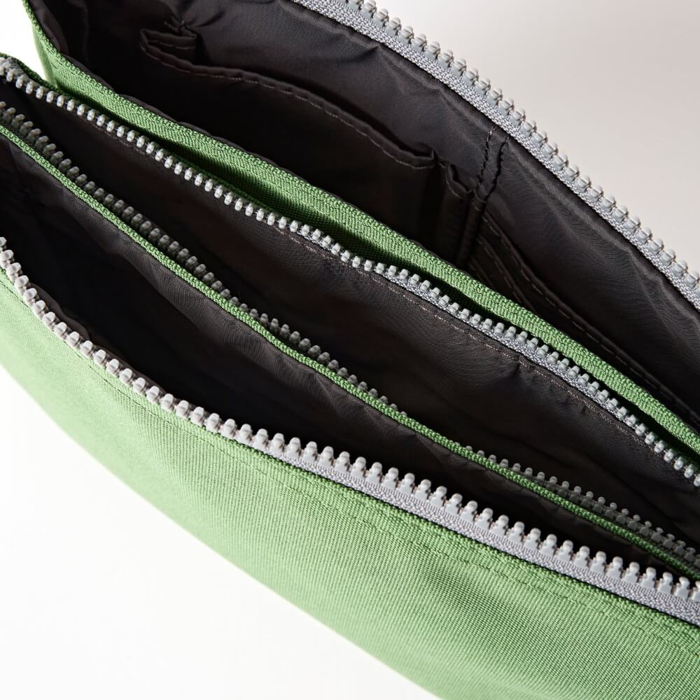 Close-up of a green bag with a zipper on a white background