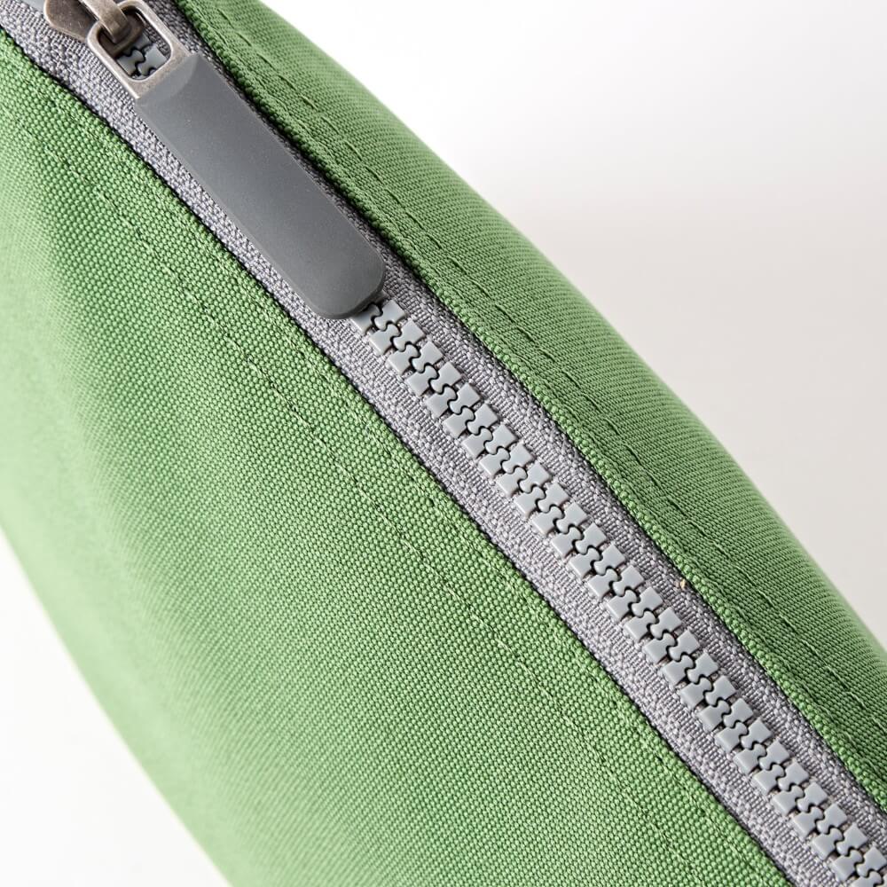 Green fabric pouch with a gray zipper on a white background