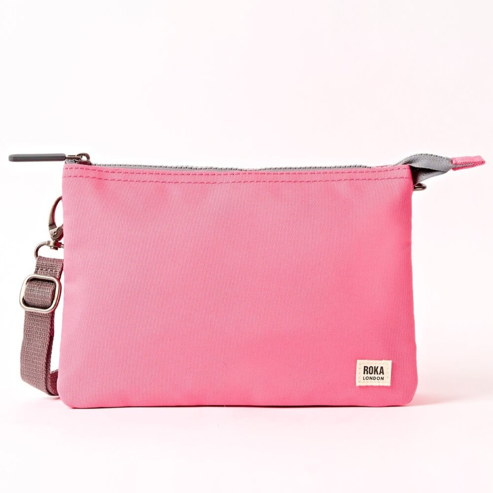 Roka Pink crossbody with a strap on a white background
