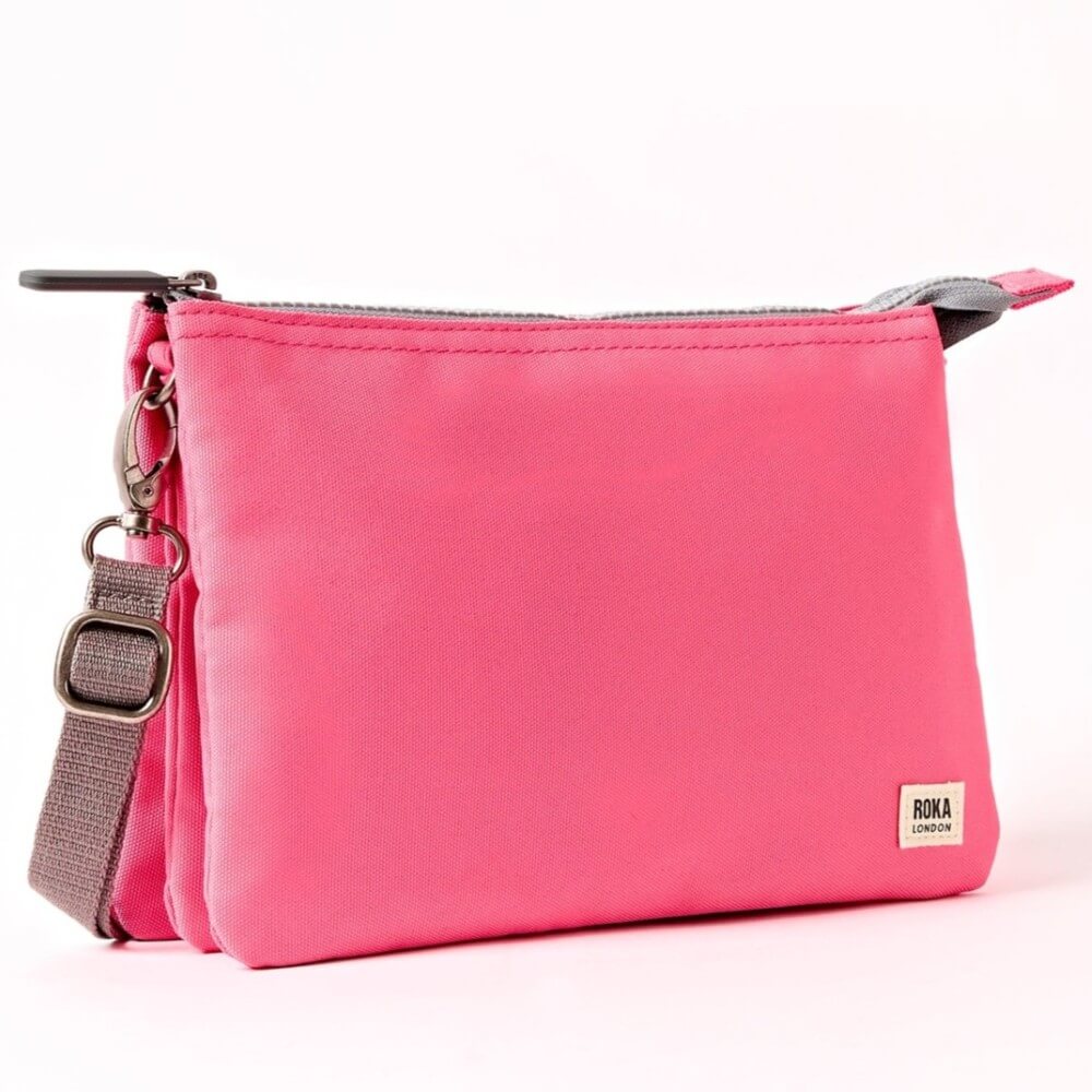 Roka Pink crossbody with a strap on a white background
