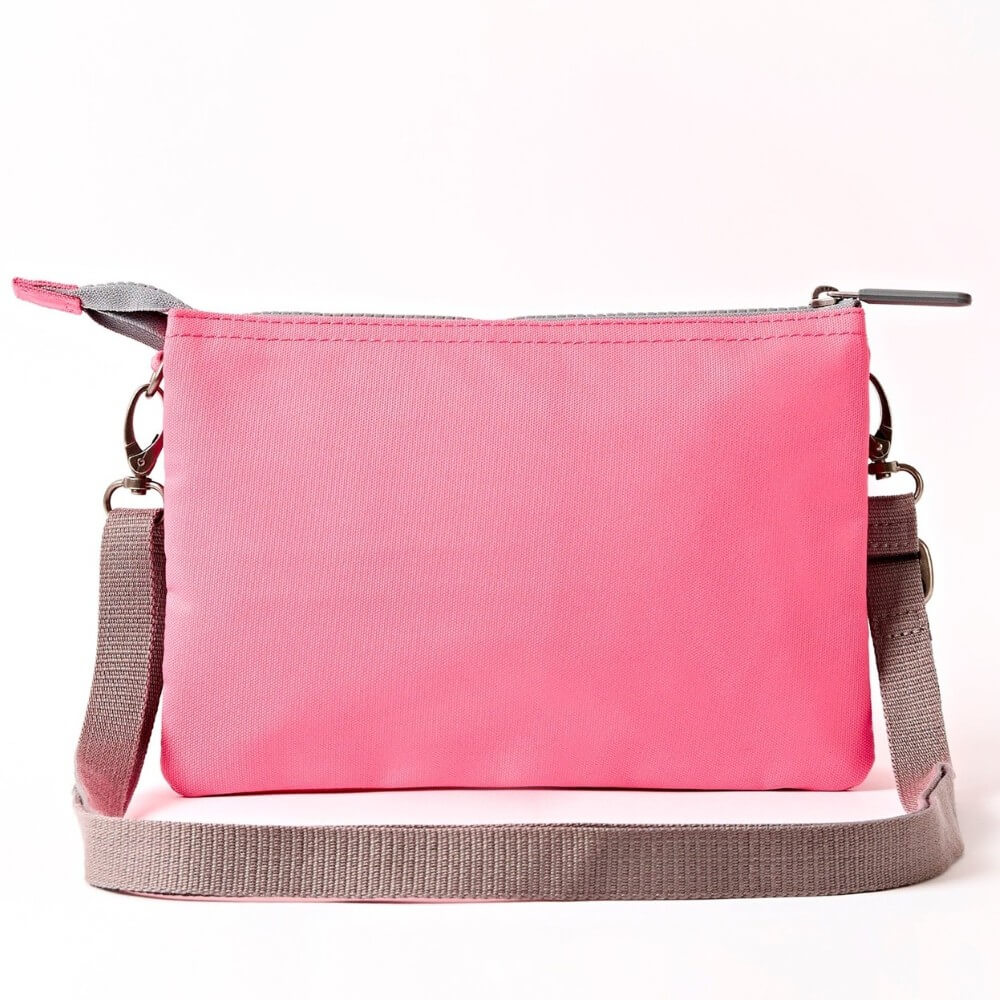 Roka Pink crossbody with a strap on a white background