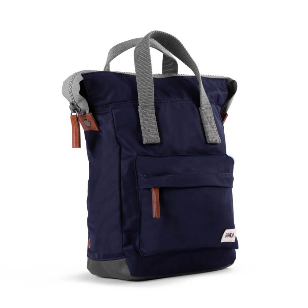 Navy blue backpack with gray straps and brown accents on a white background