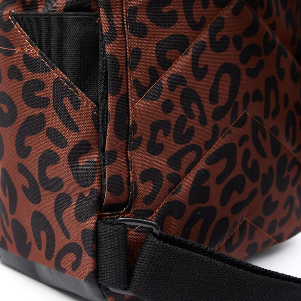 Close-up of a brown bag with black leopard print pattern on a white background