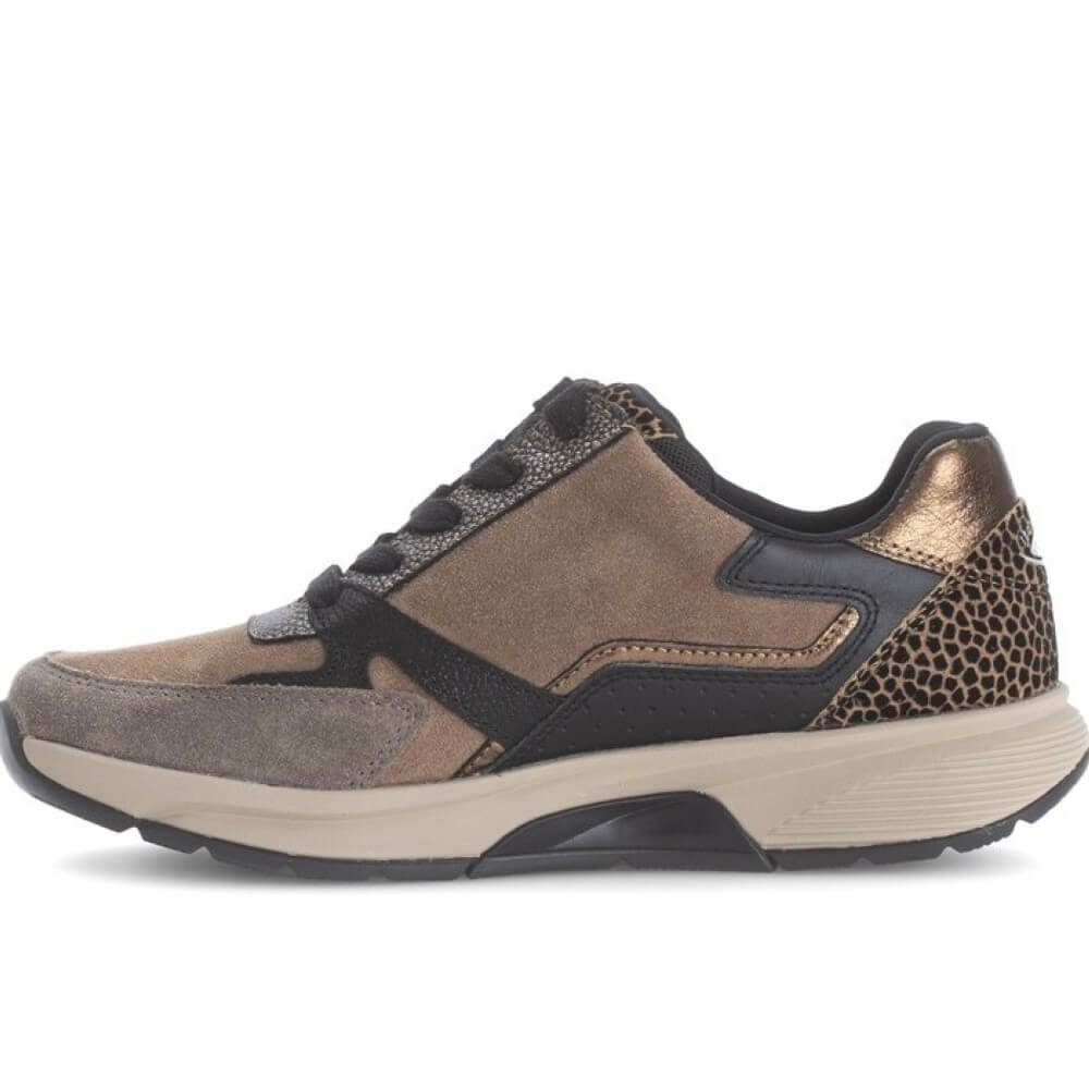A low-top sneaker shown in a side profile view on a white background. The shoe features a mix of taupe brown suede, black leather panels, a metallic bronze heel counter, and a leopard-print pattern on the heel.