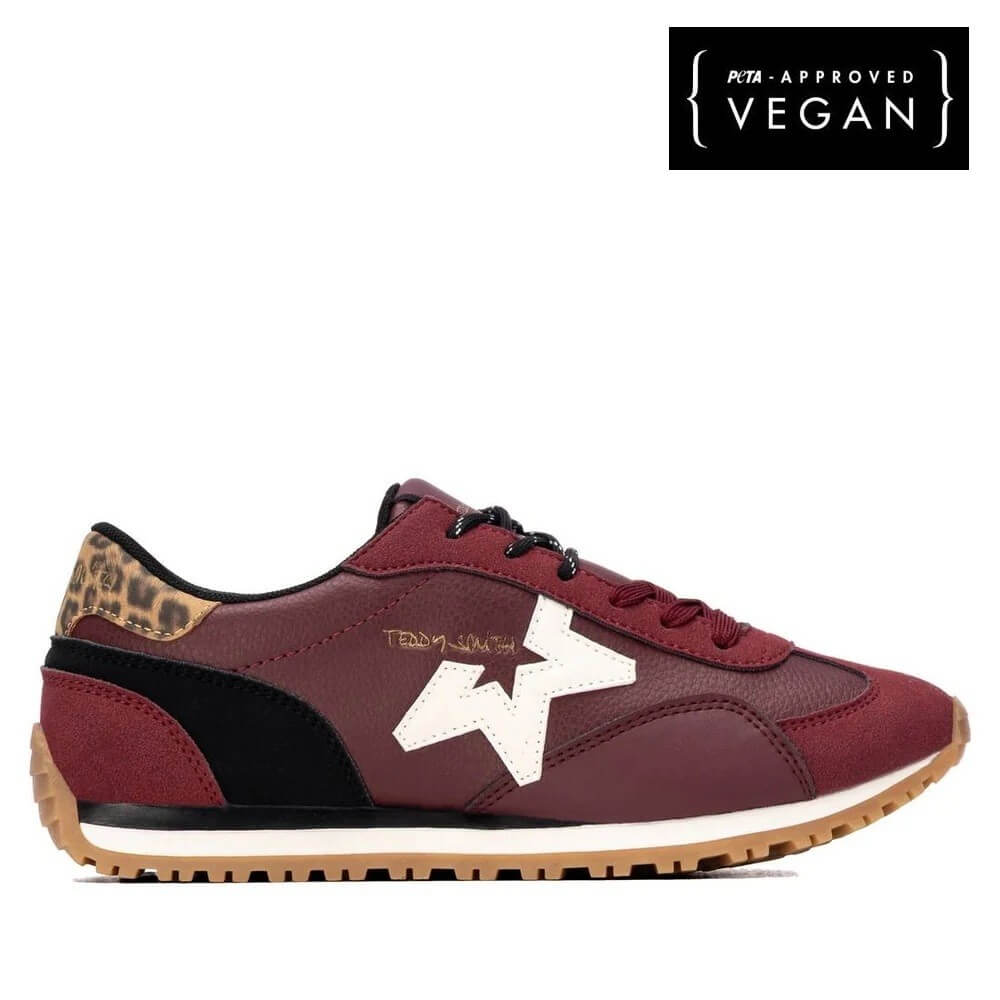 A Teddy Smith low-top sneaker in burgundy and black with a white star logo, a leopard print heel tab, and a gum sole, shown in profile against a white background. A black badge in the top right corner reads 'PETA-APPROVED VEGAN'.