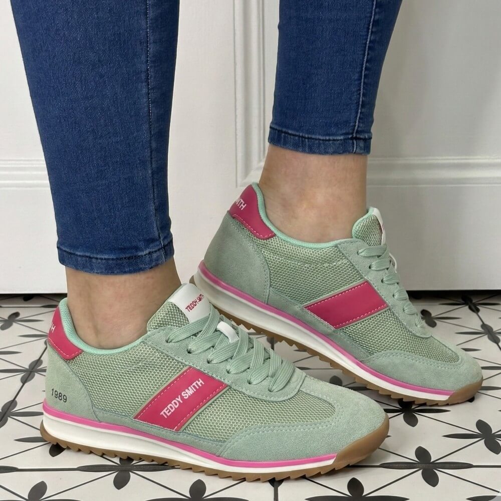 Green and pink sneakers with 'Teddy Smith' branding worn on a tiled floor.