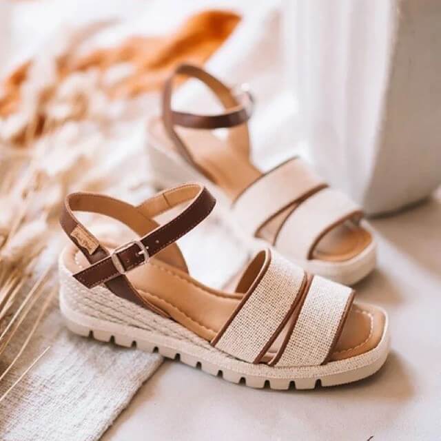 Pair of Toni Pons beige sandals with brown straps on a light background