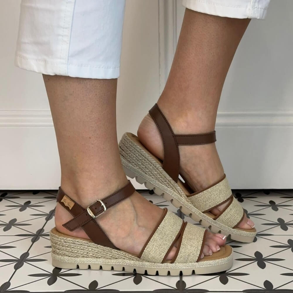 Toni Pons Brown and beige sandals worn with white pants against a neutral background