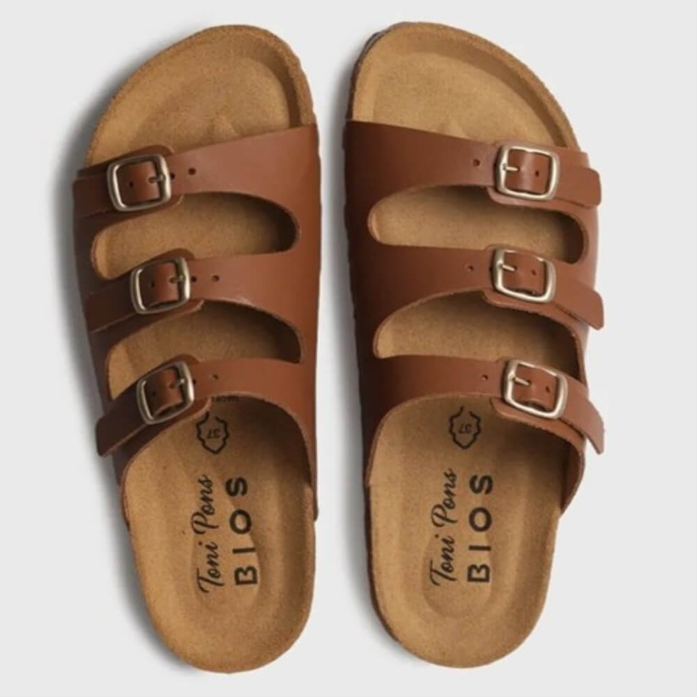 Pair of Toni Pons brown sandals with buckles on a light grey background