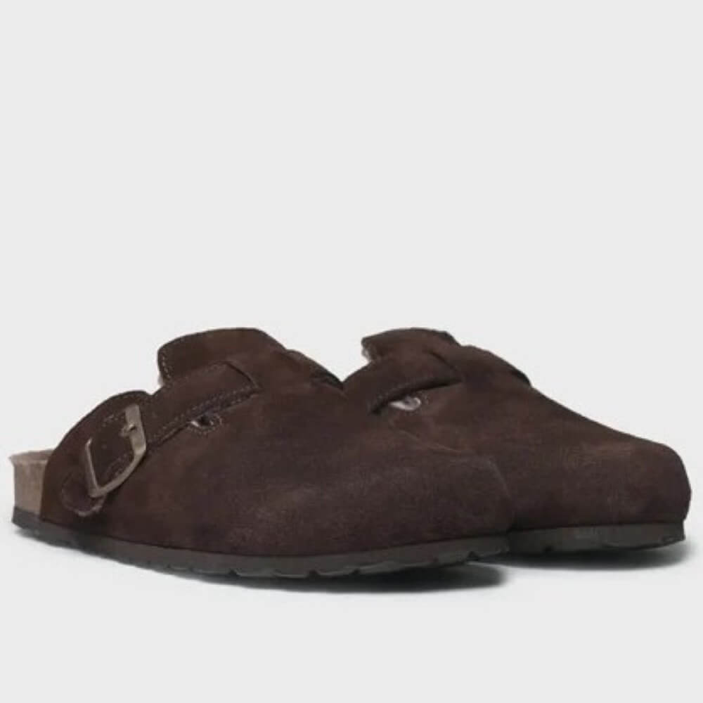 A pair of dark brown suede clogs with double straps and metal buckles, shown against a plain light gray background.