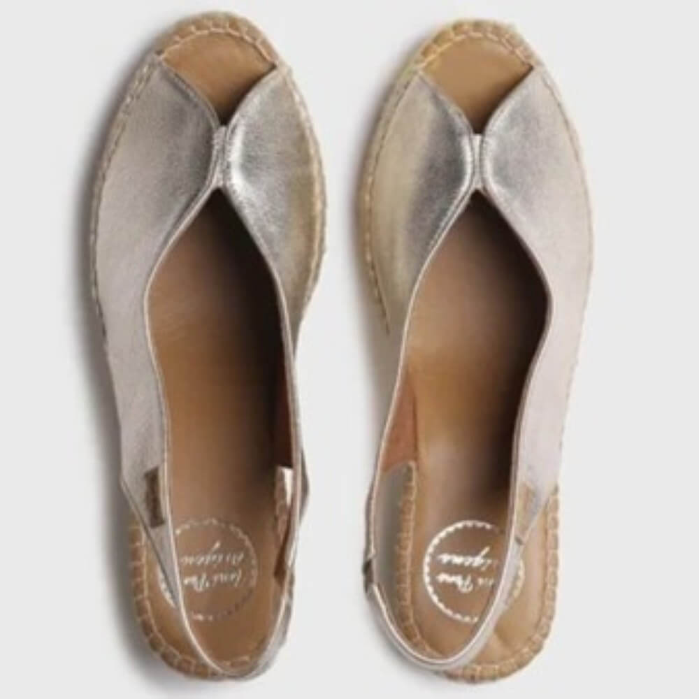 Pair of Toni Pons Gold open-toe shoes on a light grey background