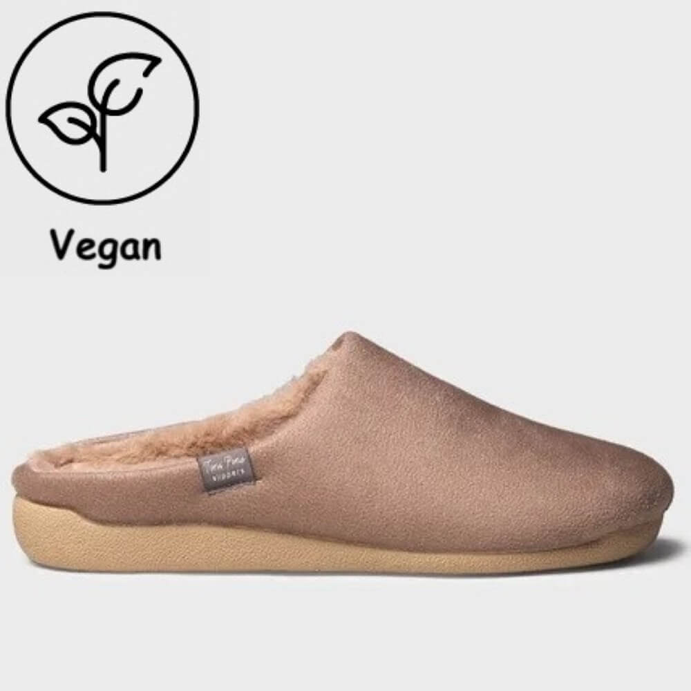 A Toni Pons slip-on mule slipper in a dusty mauve-brown suede-like finish with a soft cream sherpa lining and a tan outsole, shown on a light gray background. A black 'Vegan' leaf icon is in the top-left corner.