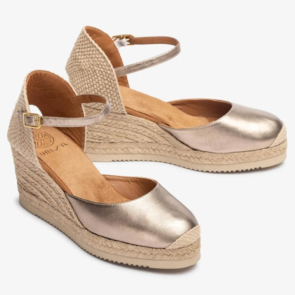 Pair of Unisa metallic wedge sandals with jute sole on a white background