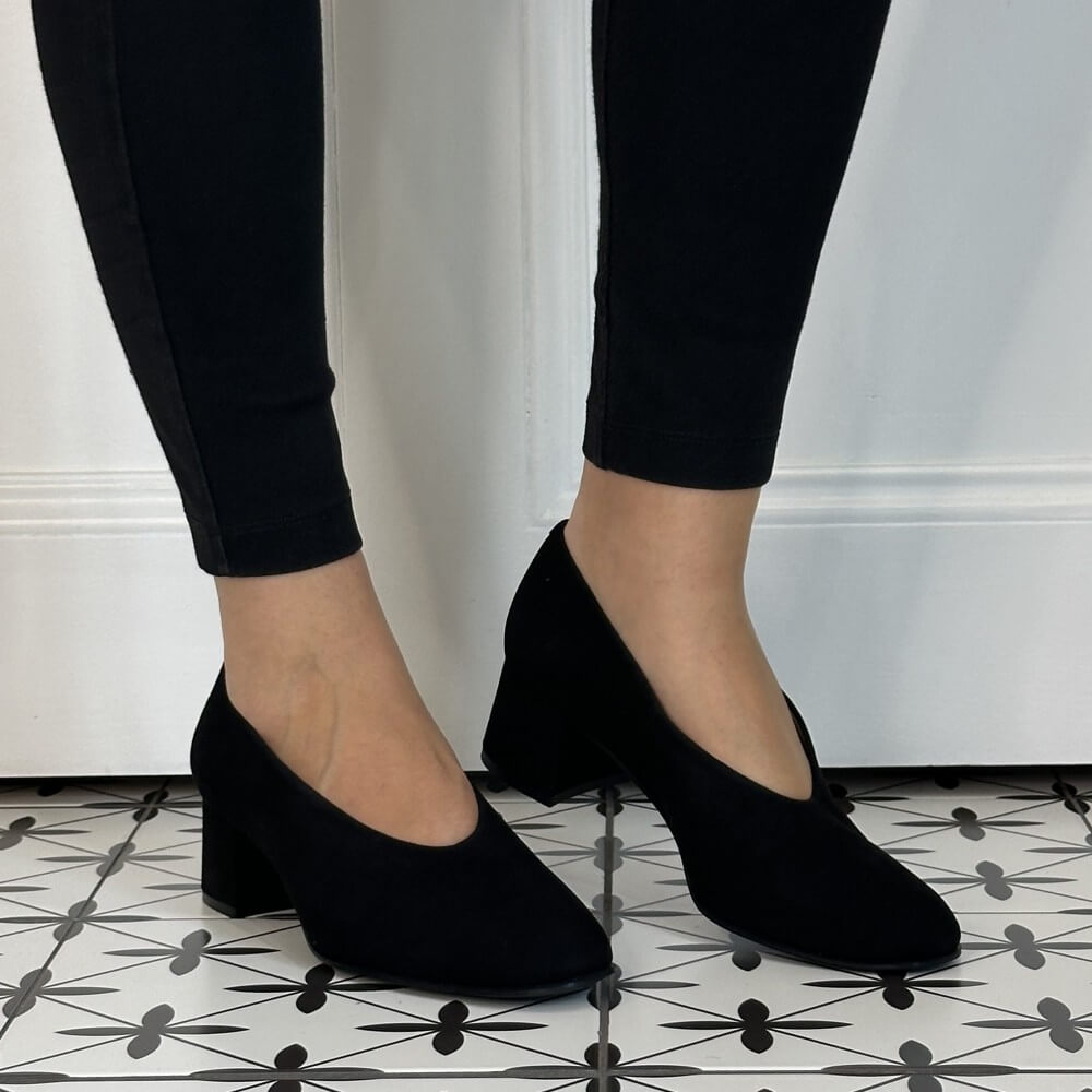 Unisa Black Suede Block heel court shoe worn with black pants on a tiled floor