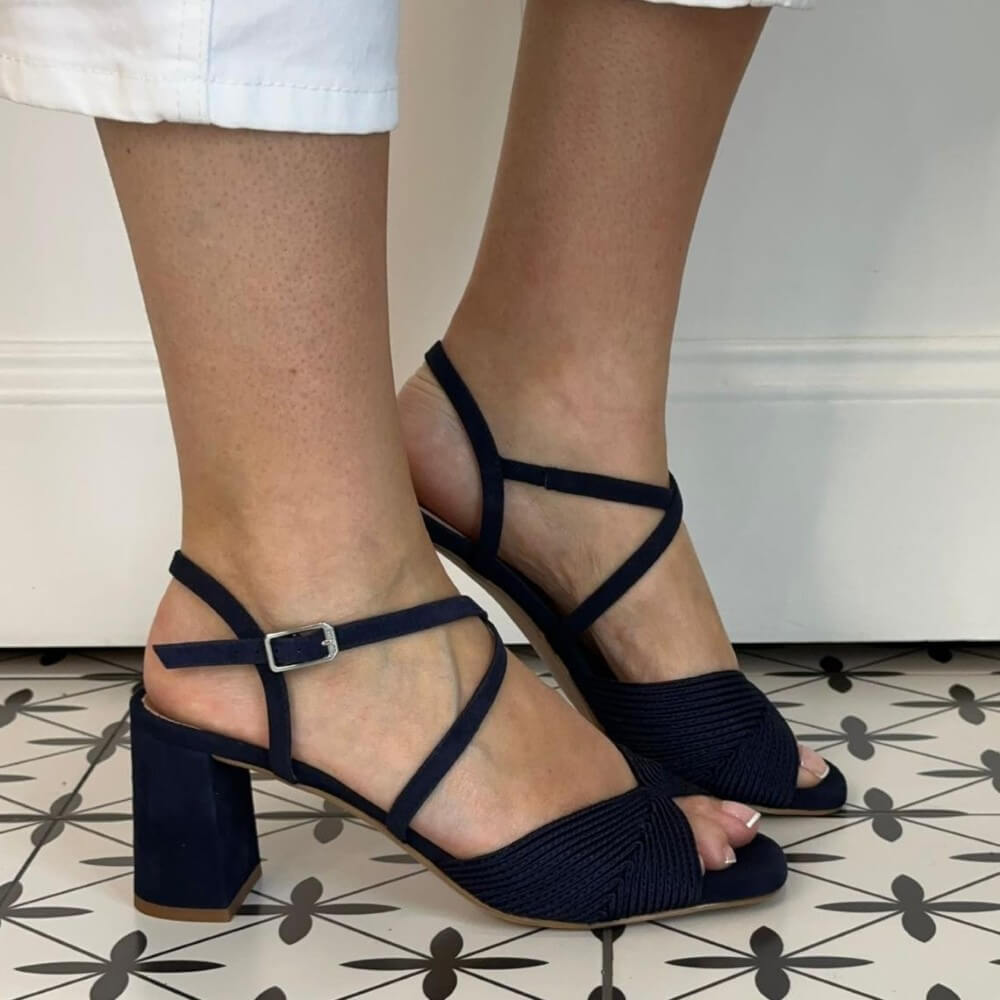 Unisa Navy blue block-heel sandals worn by a person on a patterned floor.