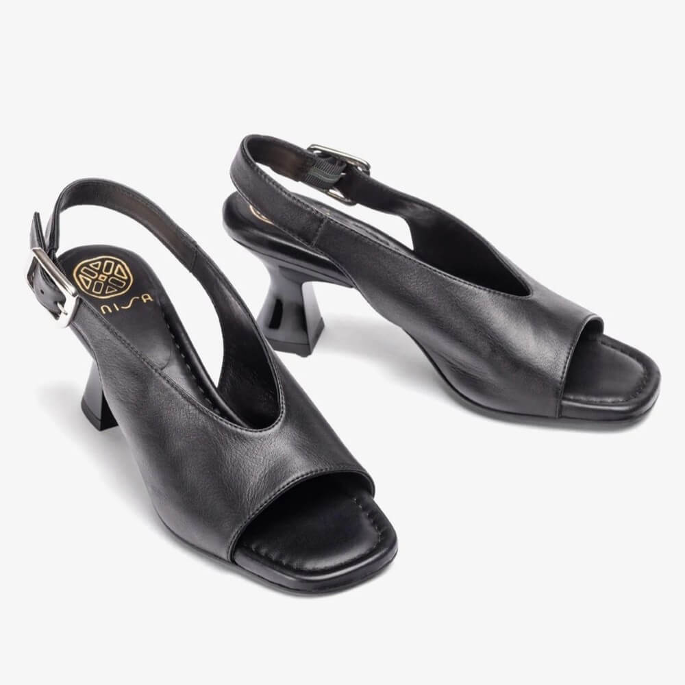 Unisa Black Slingback Peep-toe sandal with a buckle on a white background