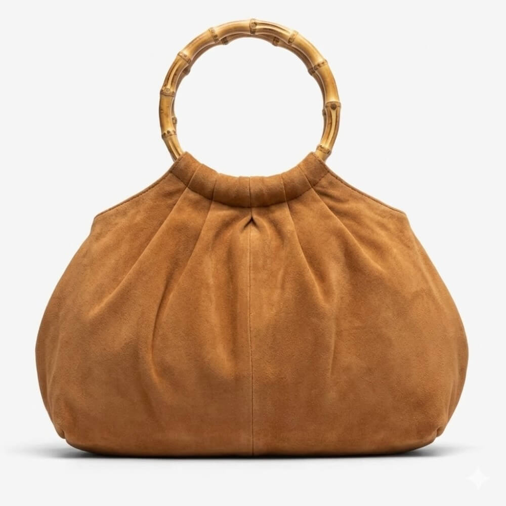 Unisa Brown suede handbag with bamboo handle on a white background