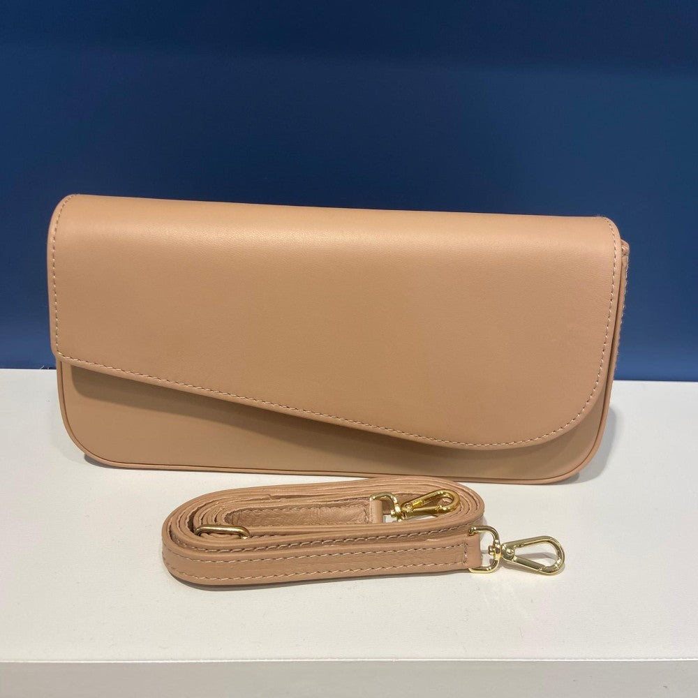 Unisa Beige handbag with matching strap on a white surface with blue background