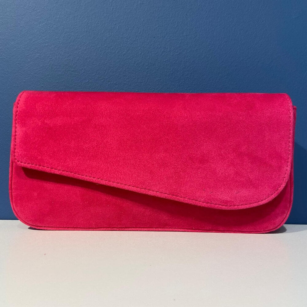 Unisa Pink clutch bag on a white surface with a blue background