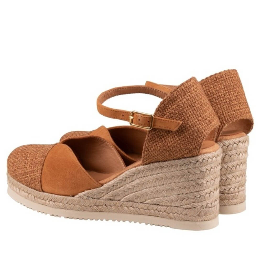 Brown wedge sandals with espadrille sole on a white background
