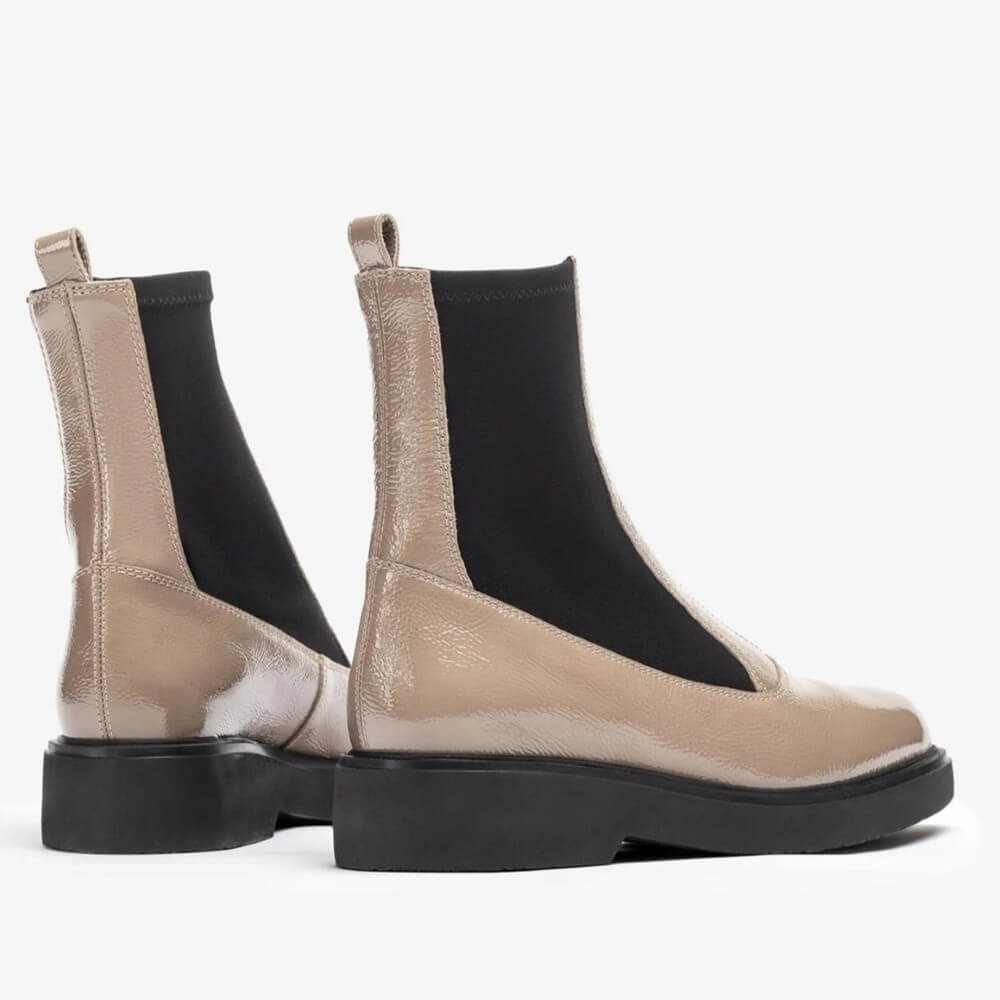 Pair of beige Chelsea boots with black soles on a white background Unisa Foggia Centre Zip Patent Leather Boot Taupe