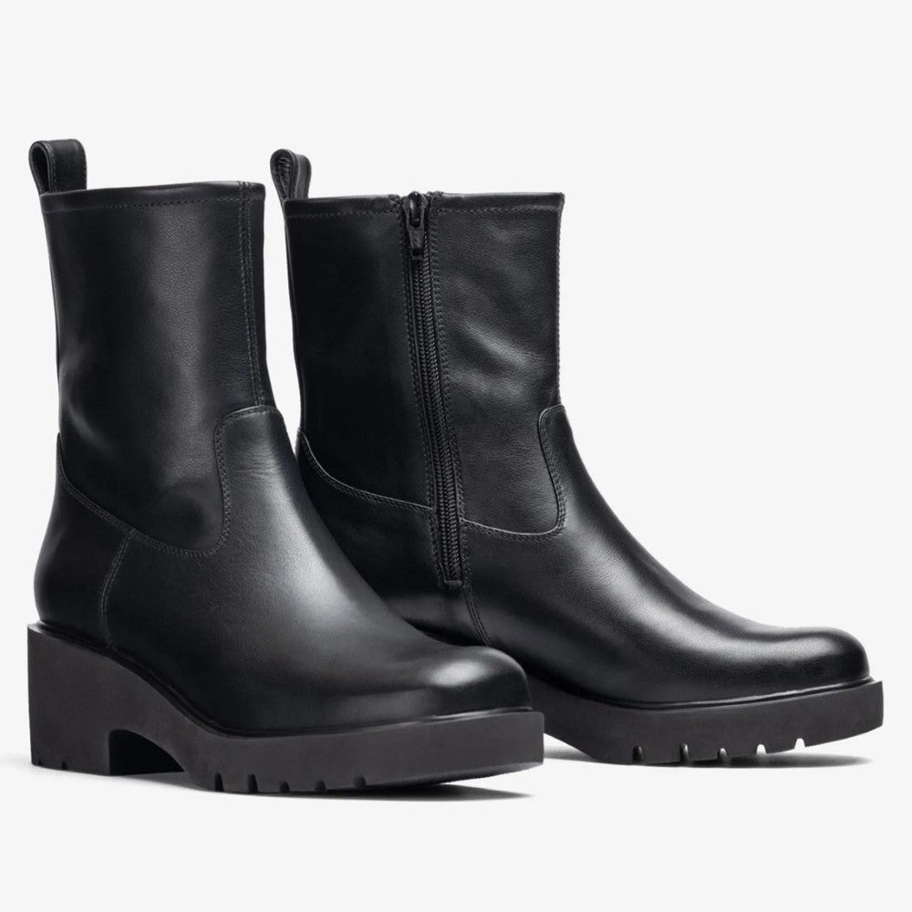 Pair of black leather ankle boots on a white background