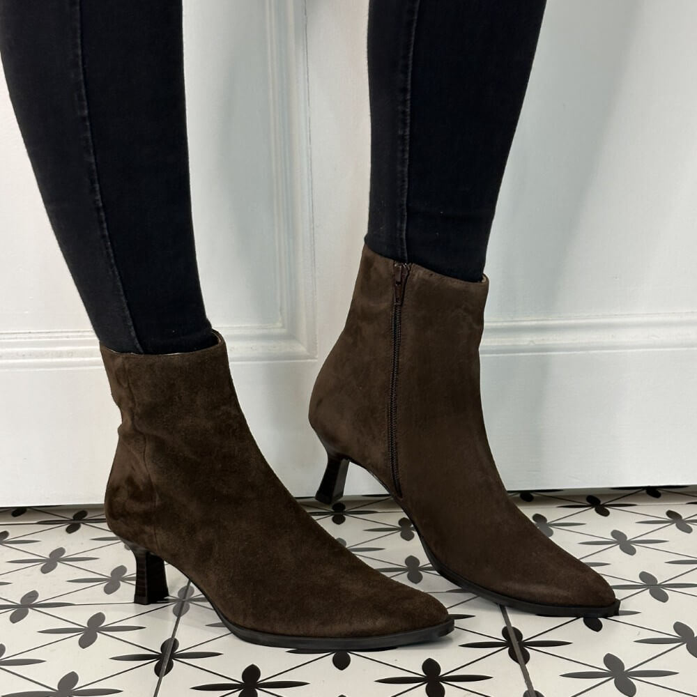 Brown Suede Heel Ankle Boots worn with black leggins on a pattern floor