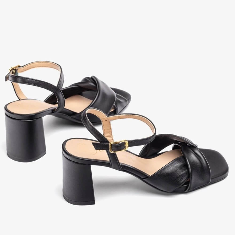 Black Leather sandal with a block heel on a white background. Unisa Medway