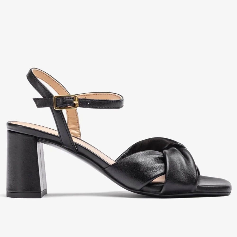 Black Leather sandal with a block heel on a white background. Unisa Medway